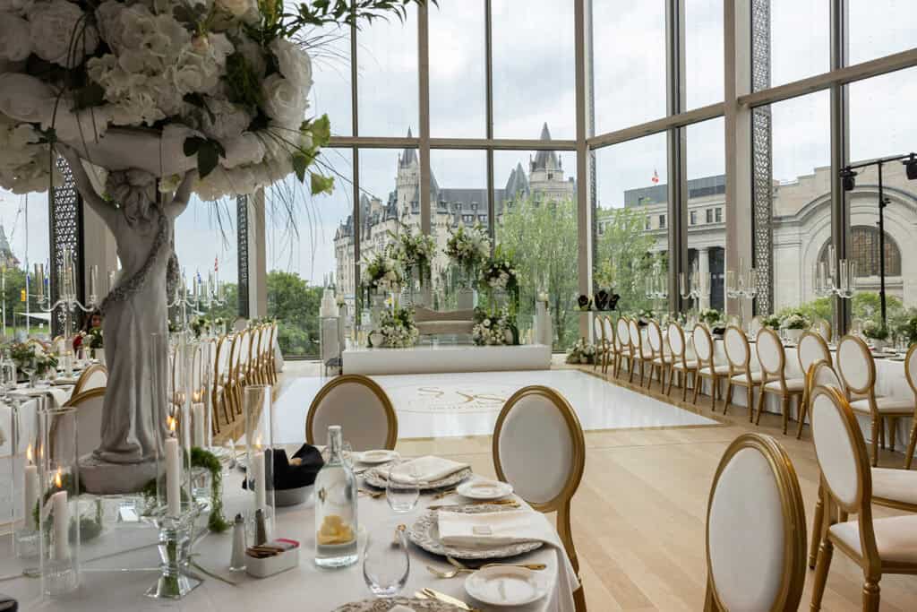 Wedding reception decor at the National Arts Center in Ottawa, with the city in the background