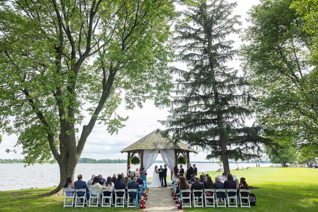 Wedding ceremony by the river at the Chateau Montebello, QC